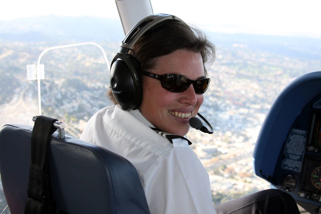 "pilot woman wearing headset"